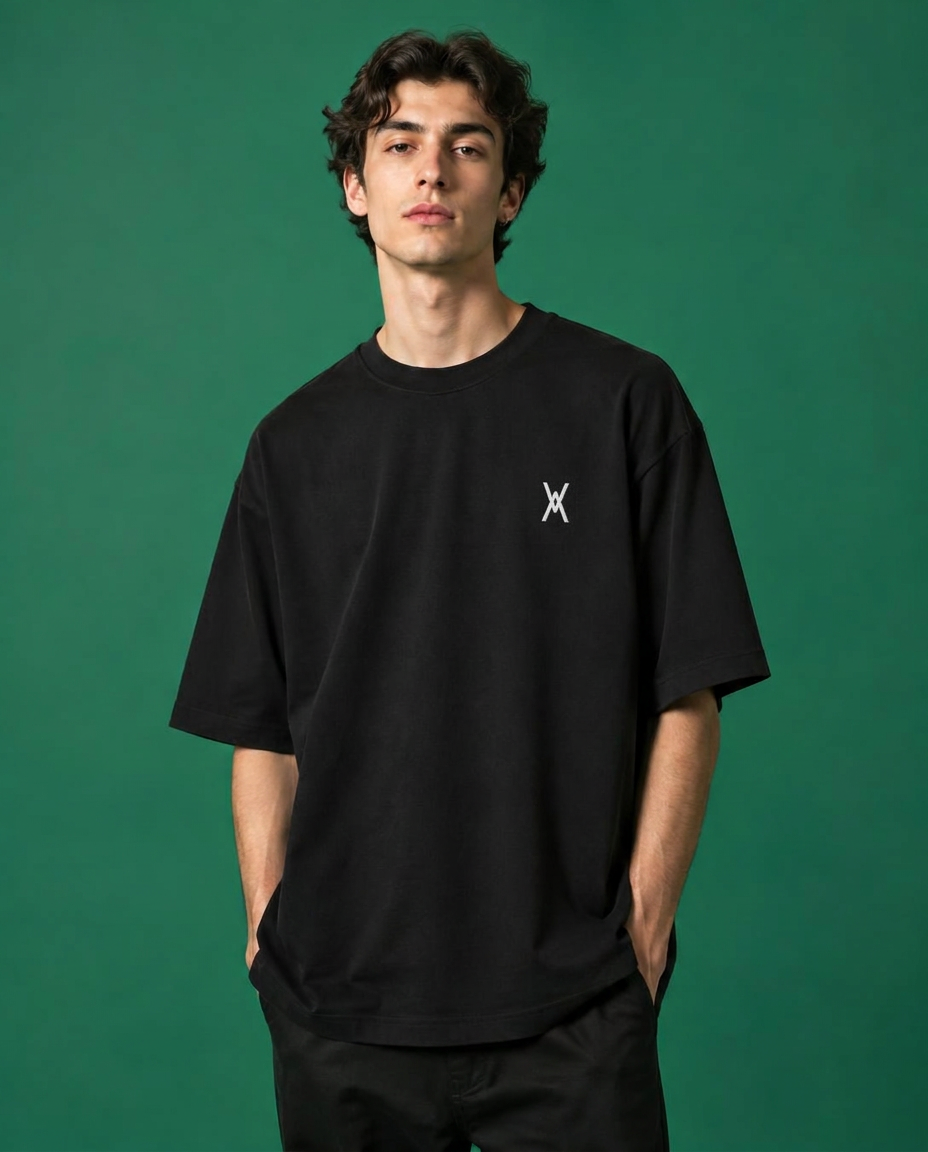 Model in black tee on green backdrop